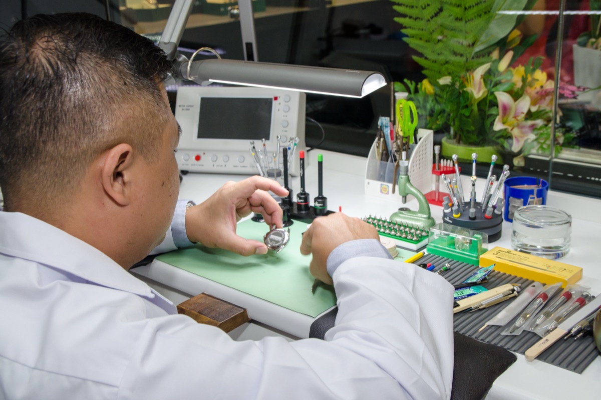 DeChronos watchmaker conducting precision repairs at our KL service centre